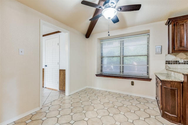 unfurnished dining area featuring ceiling fan and light tile patterned floors