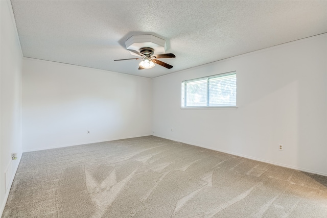 unfurnished room with ceiling fan, a textured ceiling, and carpet floors