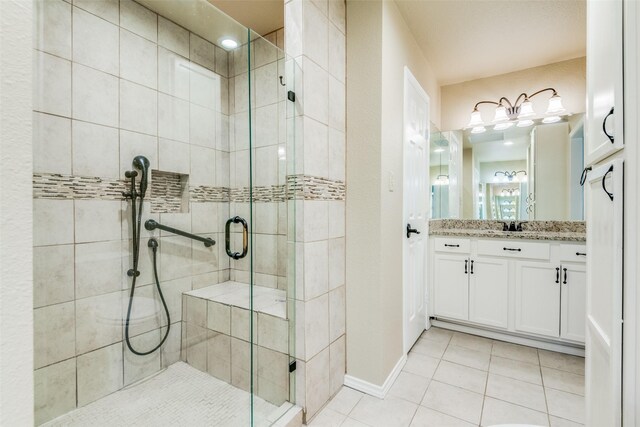 bathroom with vanity, walk in shower, and tile patterned floors