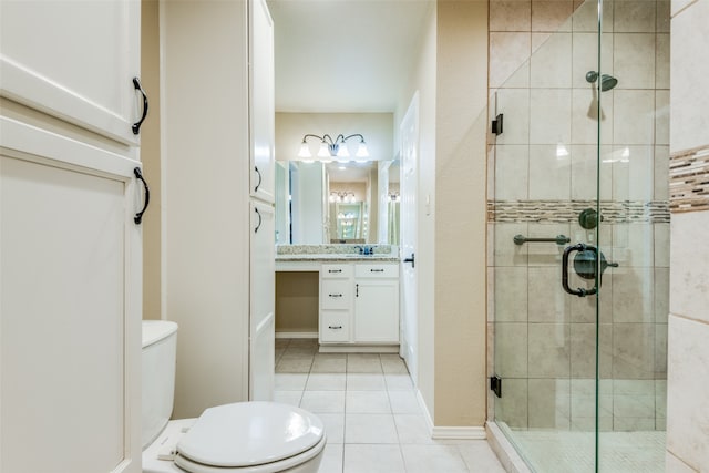 bathroom featuring tile patterned flooring, toilet, vanity, and walk in shower