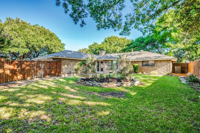 rear view of property with a lawn