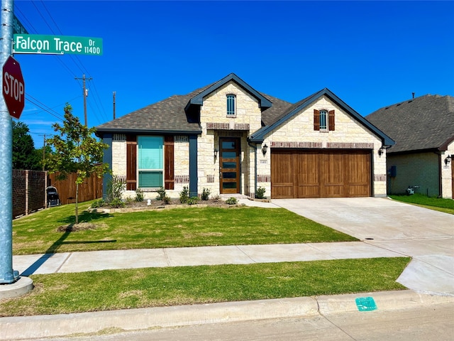 view of front facade with a garage and a front yard