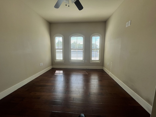 spare room with ceiling fan and dark hardwood / wood-style floors