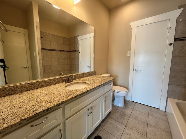 full bathroom with tile patterned flooring, tiled shower / bath, vanity, and toilet