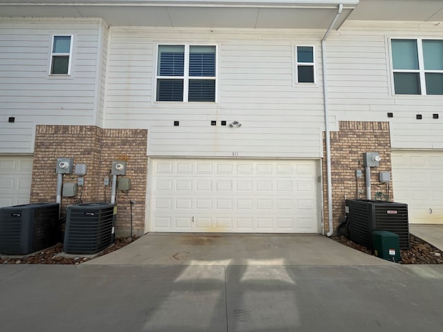 exterior space featuring central AC and a garage