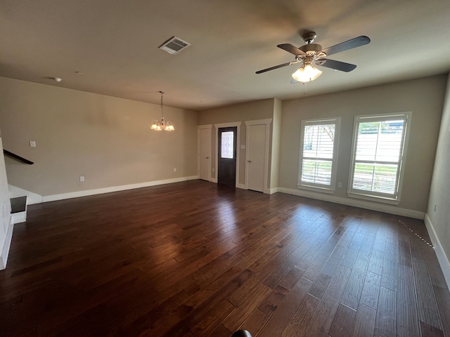 unfurnished living room featuring dark hardwood / wood-style flooring and ceiling fan with notable chandelier