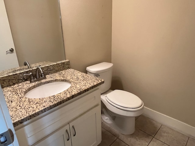 bathroom featuring tile patterned floors, vanity, and toilet