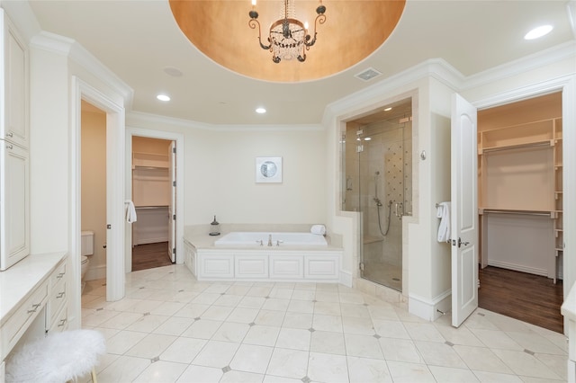 bathroom featuring independent shower and bath, crown molding, hardwood / wood-style floors, and a chandelier