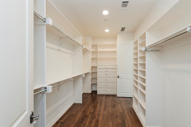 walk in closet with dark hardwood / wood-style floors