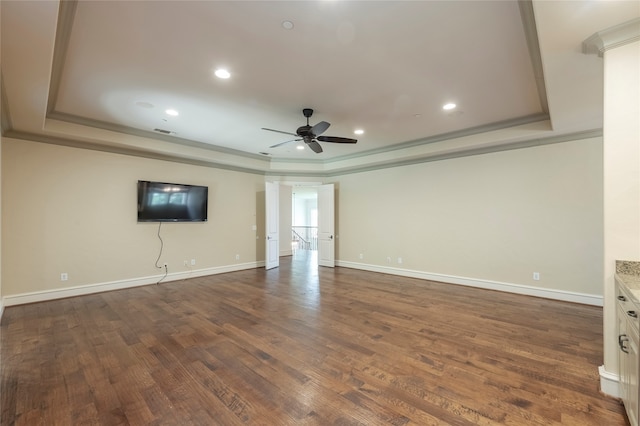 unfurnished living room with ceiling fan, a raised ceiling, ornamental molding, and wood-type flooring