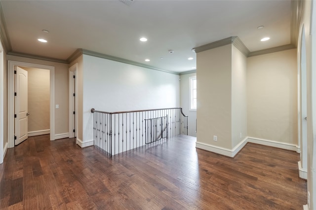 empty room featuring crown molding and dark hardwood / wood-style flooring