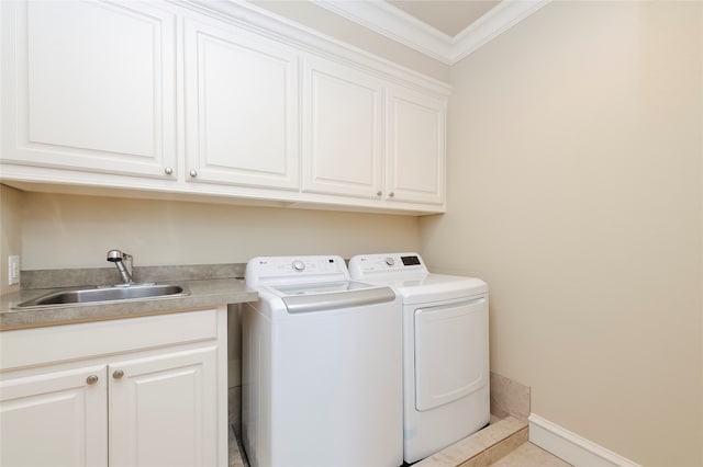 washroom with light tile patterned flooring, sink, washing machine and dryer, cabinets, and crown molding