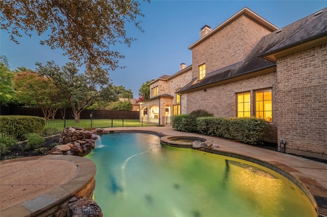 view of swimming pool with an in ground hot tub