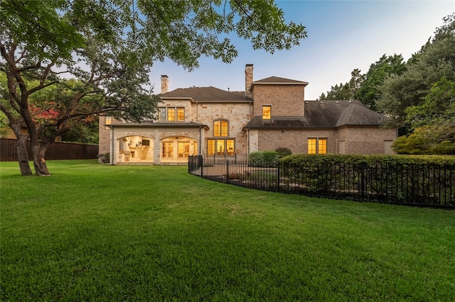 back of house featuring a yard