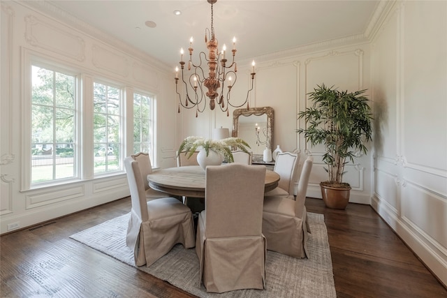 dining area featuring an inviting chandelier, dark hardwood / wood-style floors, and ornamental molding