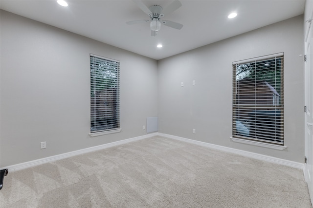 carpeted empty room featuring ceiling fan