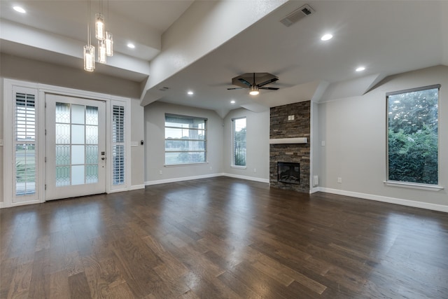 unfurnished living room featuring a fireplace, ceiling fan with notable chandelier, and dark hardwood / wood-style floors