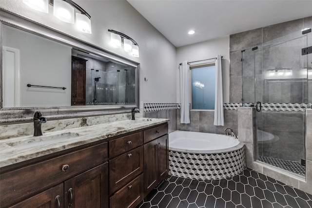 bathroom featuring double sink vanity, independent shower and bath, and tile patterned floors