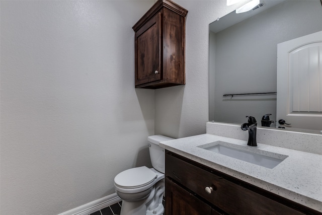 bathroom featuring tile patterned floors, toilet, and vanity