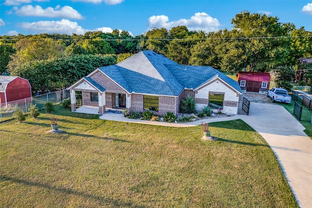 single story home featuring a garage, a front lawn, and a shed