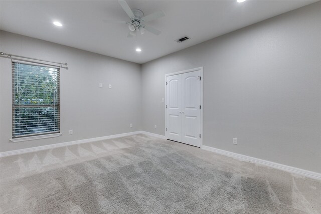 spare room with carpet floors and ceiling fan