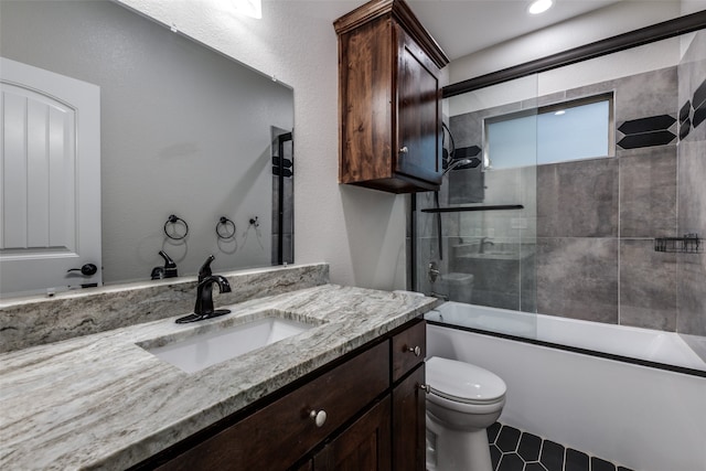 full bathroom featuring tile patterned floors, vanity, combined bath / shower with glass door, and toilet