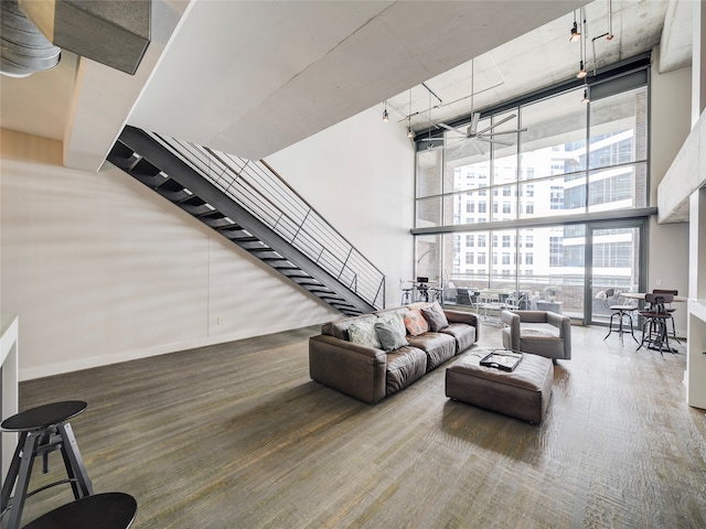 interior space featuring a high ceiling, wood-type flooring, and expansive windows