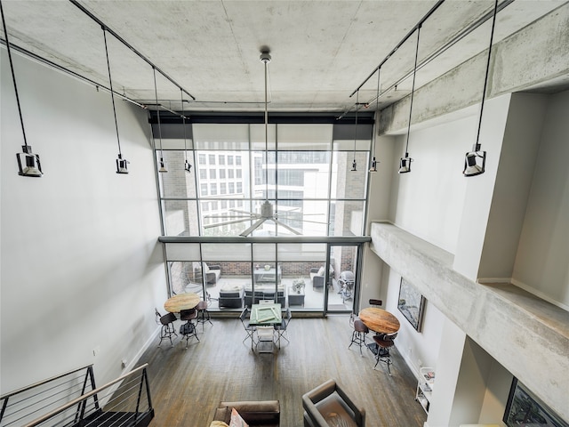 interior space with a wall of windows and wood-type flooring