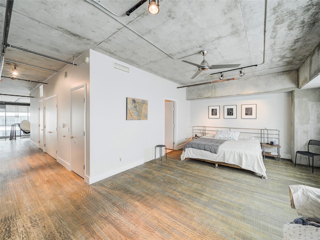 unfurnished bedroom with ceiling fan and wood-type flooring