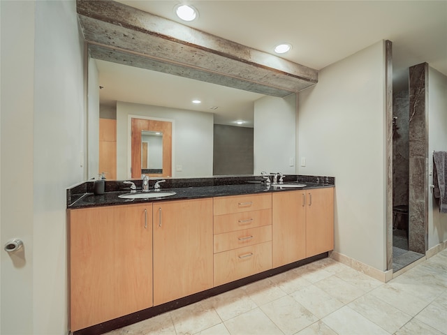 bathroom with tile patterned floors and double vanity