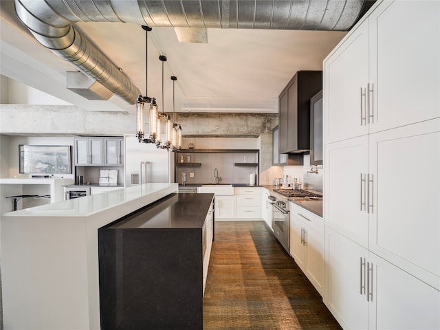 kitchen featuring dark wood-type flooring, a kitchen island, double oven range, pendant lighting, and white cabinets