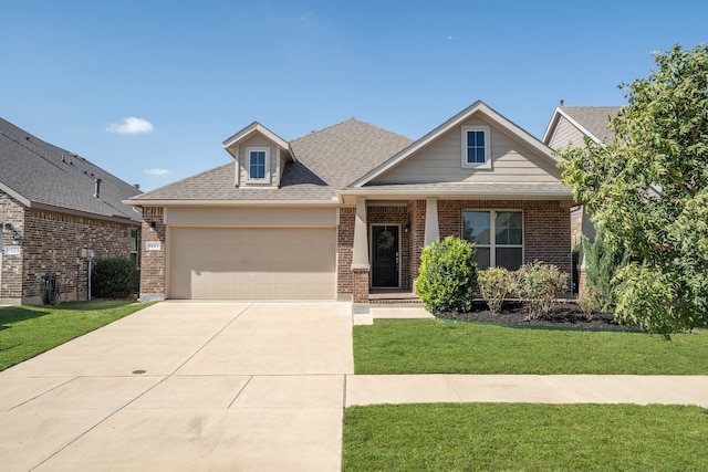 craftsman house with a front yard and a garage