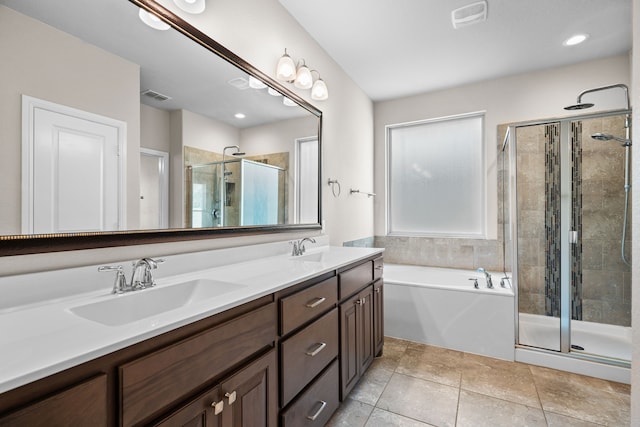 bathroom featuring vanity, tile patterned floors, and plus walk in shower