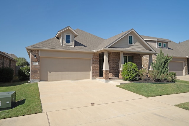 craftsman-style house with a front yard and a garage