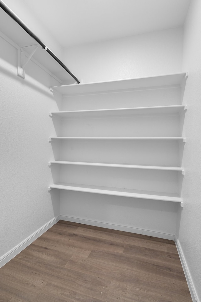 spacious closet featuring hardwood / wood-style floors