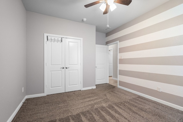 unfurnished bedroom with a closet, carpet floors, and ceiling fan