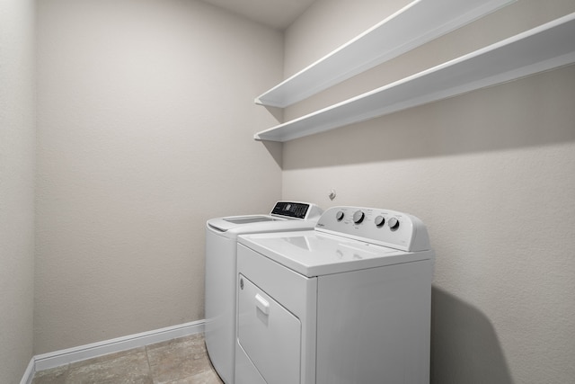 washroom with independent washer and dryer and light tile patterned floors