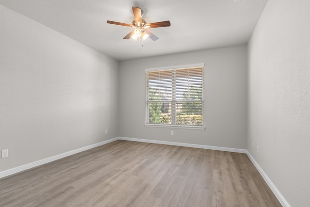 unfurnished room with light wood-type flooring and ceiling fan