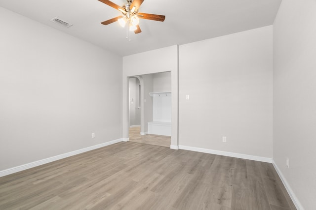 empty room with light hardwood / wood-style floors and ceiling fan