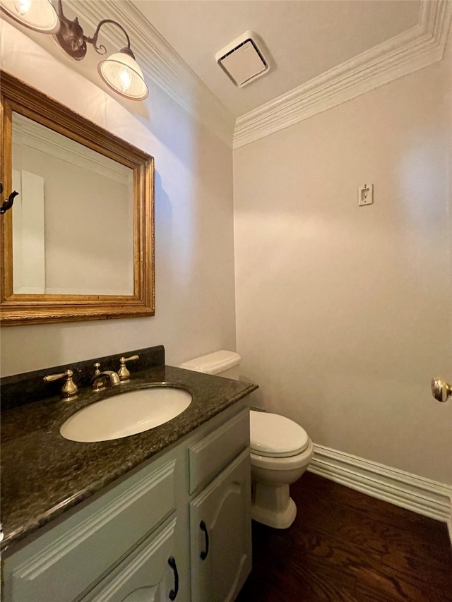 bathroom featuring ornamental molding, hardwood / wood-style flooring, vanity, and toilet