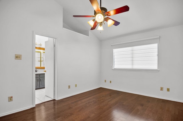 spare room featuring light wood-type flooring, lofted ceiling, ceiling fan, and a healthy amount of sunlight