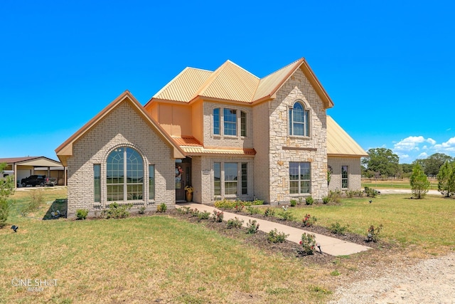 view of front of home with a front yard and a carport