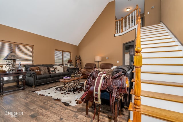 living room featuring dark hardwood / wood-style flooring and high vaulted ceiling