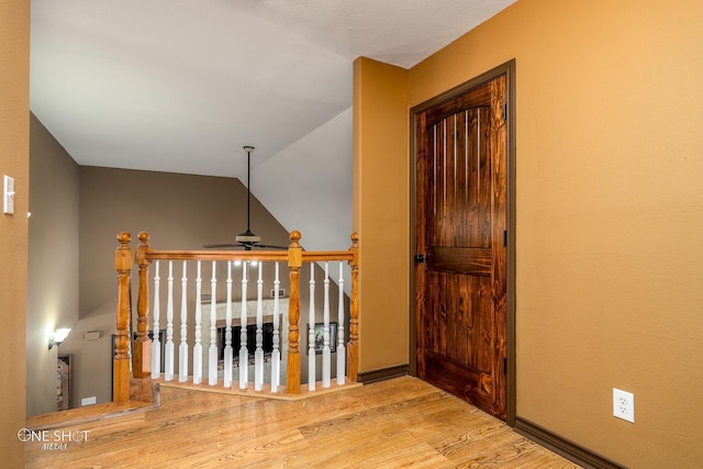 hallway featuring light hardwood / wood-style flooring and lofted ceiling