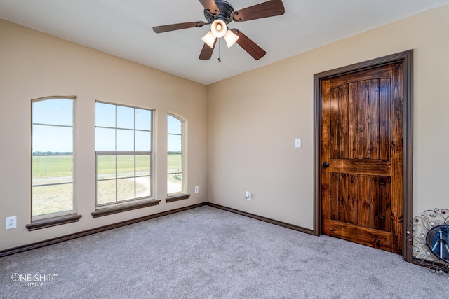 carpeted empty room with ceiling fan