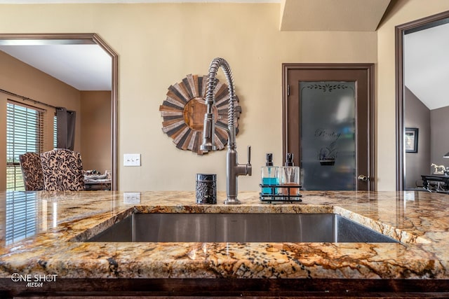 kitchen featuring vaulted ceiling and sink