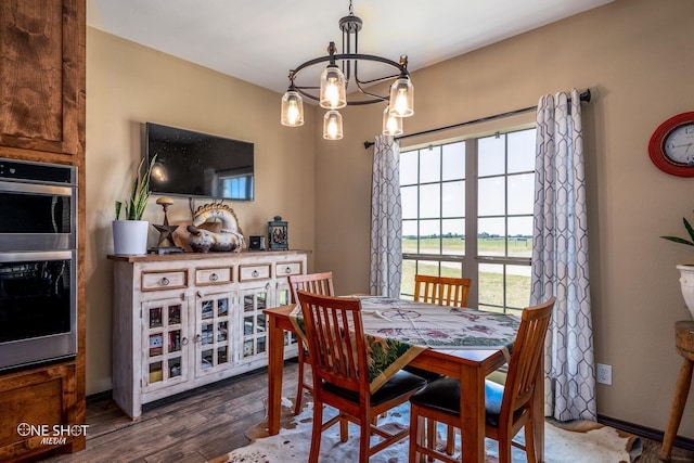 dining space featuring a notable chandelier and dark hardwood / wood-style floors