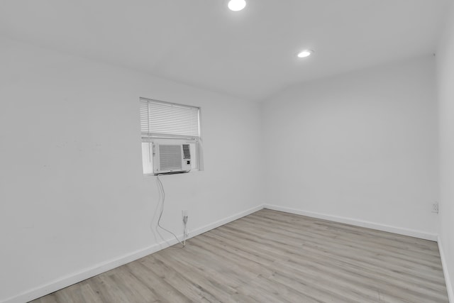 empty room featuring light hardwood / wood-style floors and cooling unit