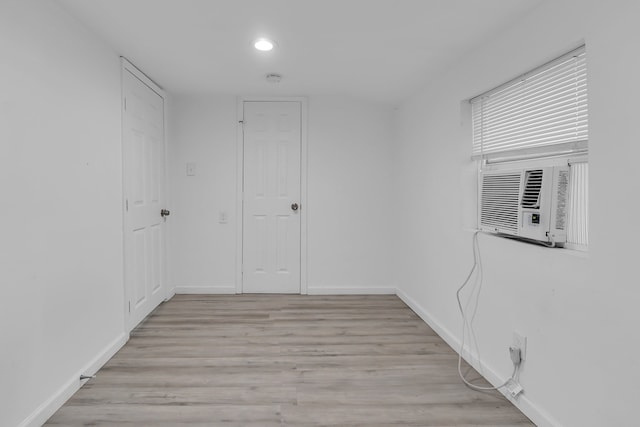 spare room with light hardwood / wood-style flooring and cooling unit