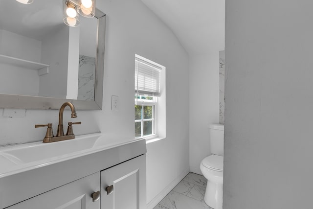 bathroom featuring vanity, toilet, and lofted ceiling